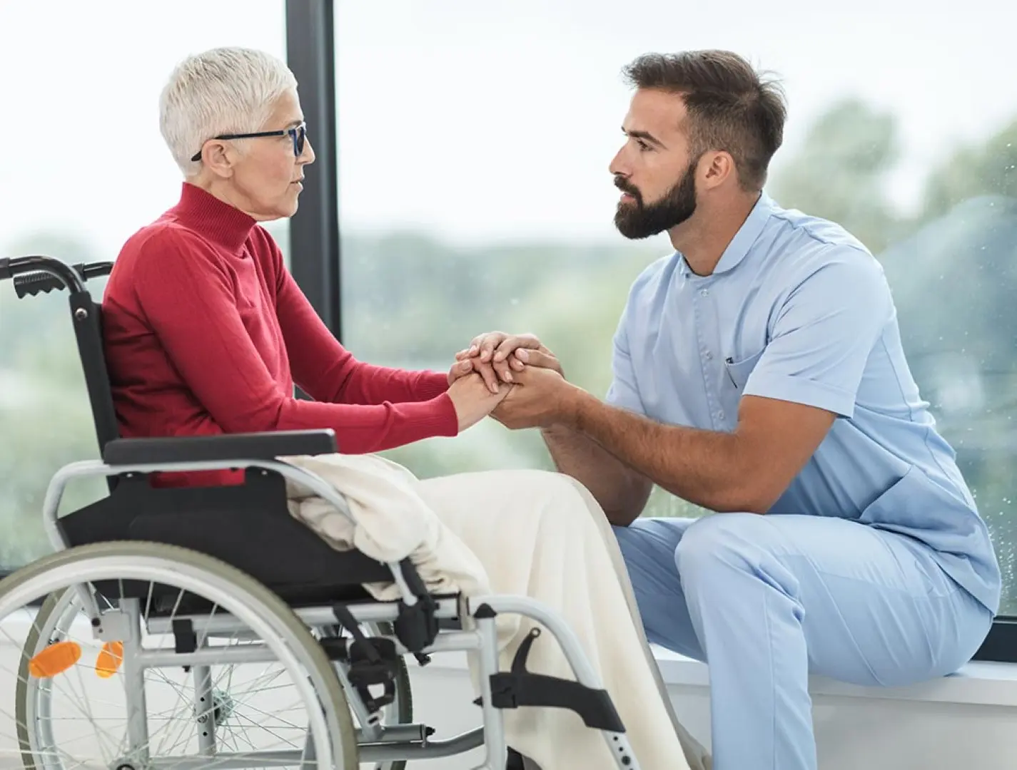 A caregiver helping a client in a wheelchair